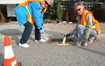 OLWQS celebrates World Rivers Day by painting yellow fish beside Osoyoos storm drains